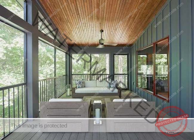 The veranda of a house with high wood-paneled ceilings, blue walls and brown furniture. 