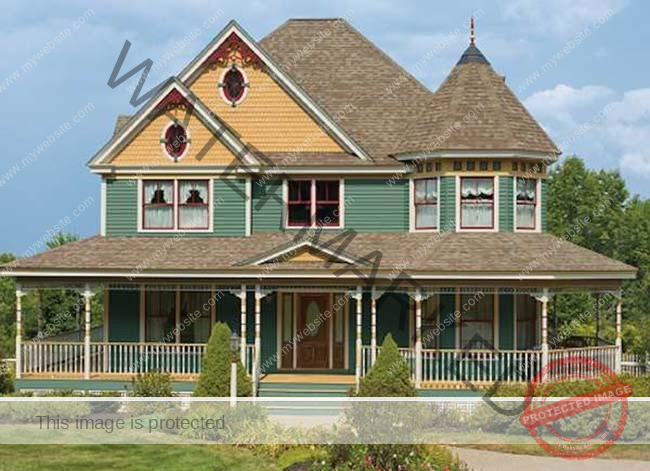 A painted woman's Victorian house is painted green with yellow and red. 