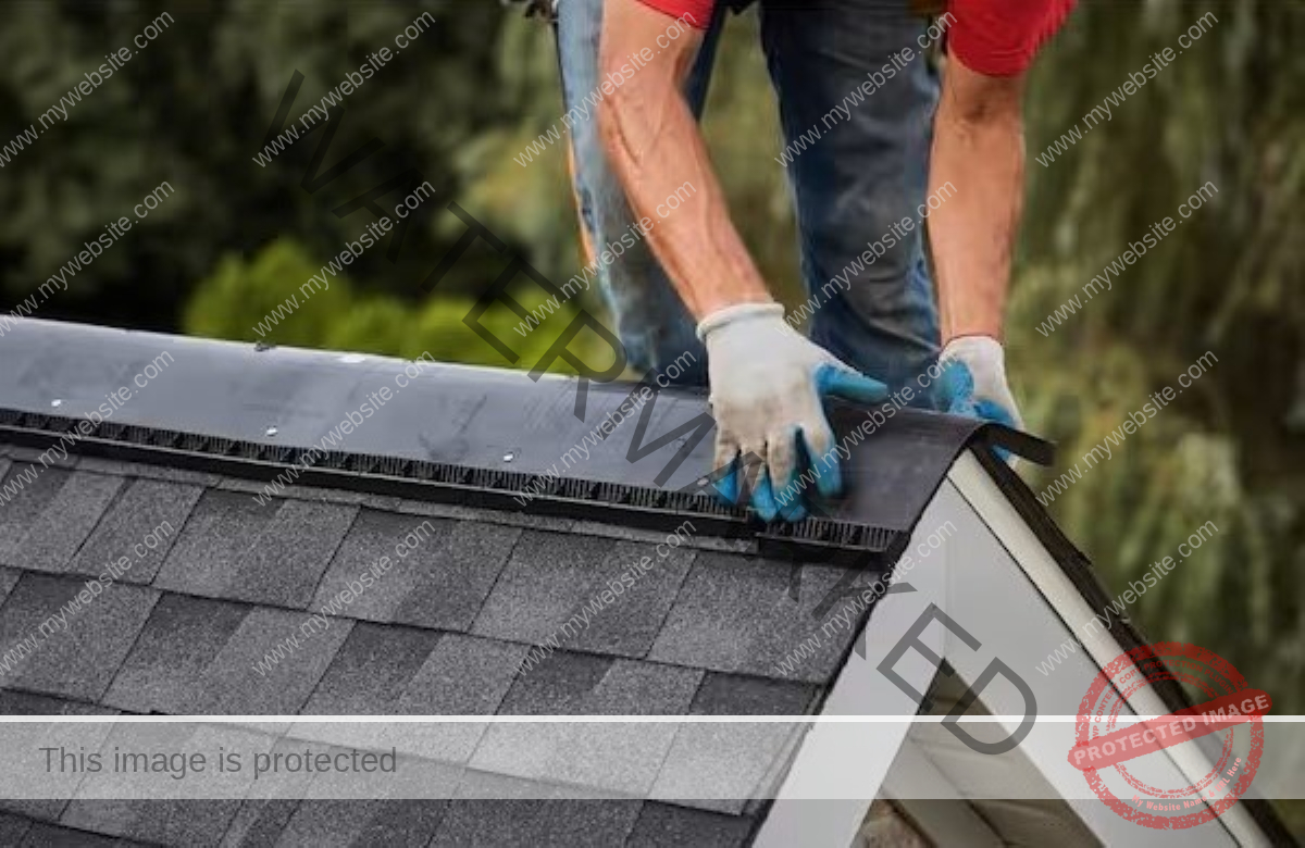 The person is adding a ridge to the top of the roof.