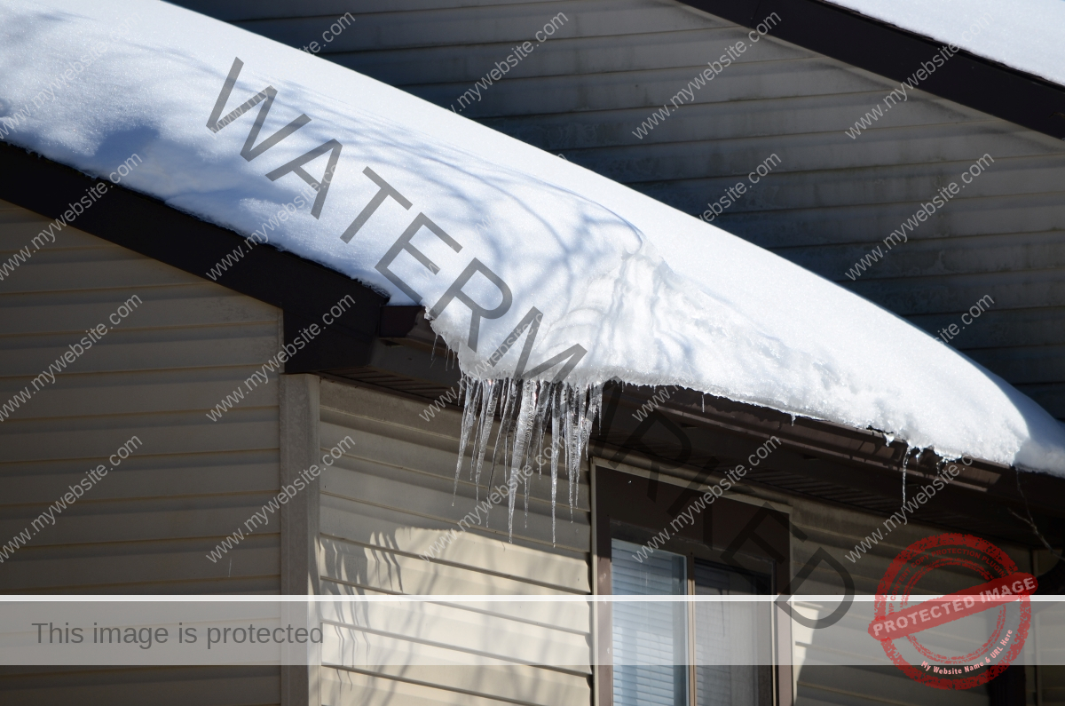 A large ice dam on the roof of a house.