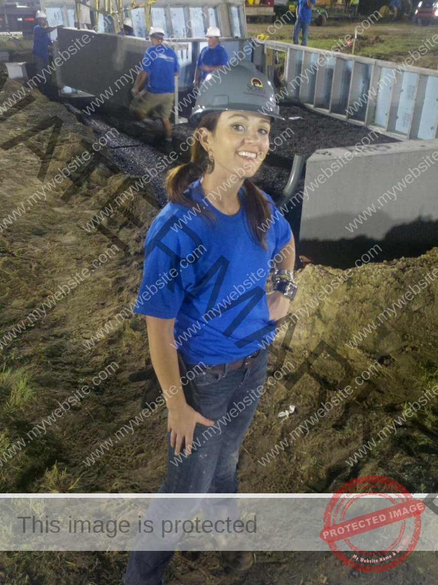 Smiling female project manager wearing a hard hat.