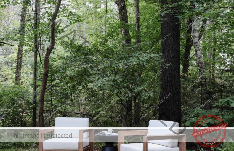 Outdoor seating in our wooded backyard. Wood and white cushioned outdoor chairs. , Nadine Stay