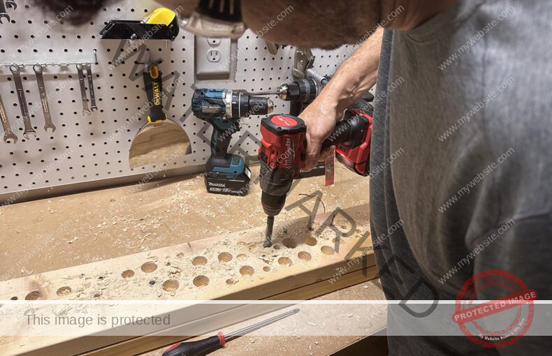 Man using a Milwaukee M18 hammer drill to drill holes in wood